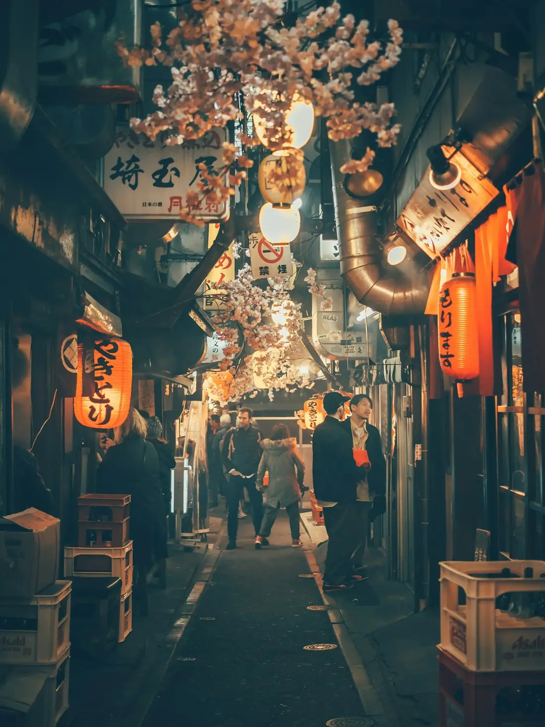 A narrow Tokyo alley of small restaurants lit by paper lanterns